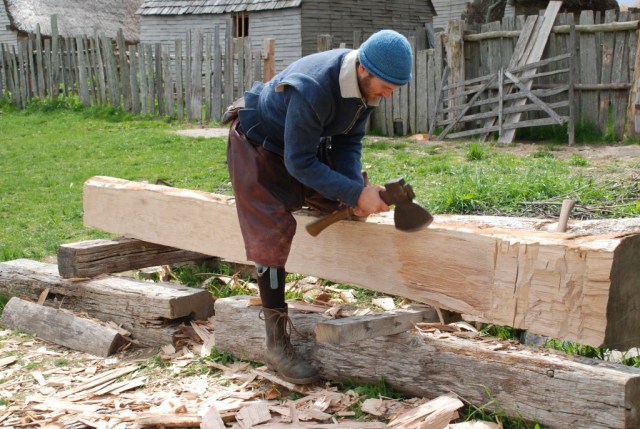 The fire gave volunteers an opportunity to practice their 17th Century building skills - Seeing plumb while hewing flat